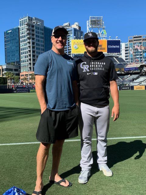 Chris Gilbreath (left) with son Lucas on the first base line at Petco Park in San Diego.
