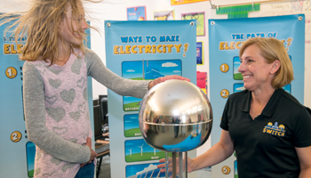 Child with educator doing experiment