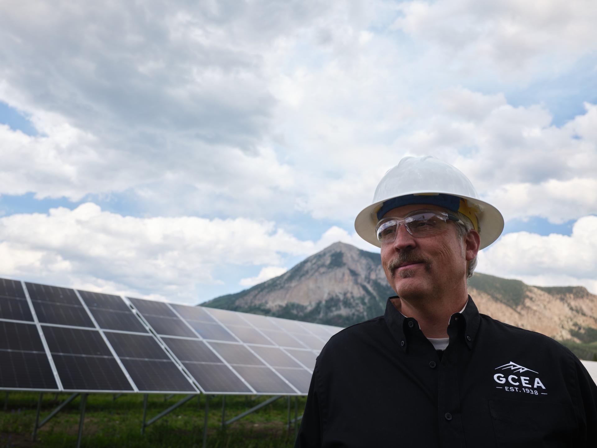 Matt Feier looking optimistic in front of solar panels