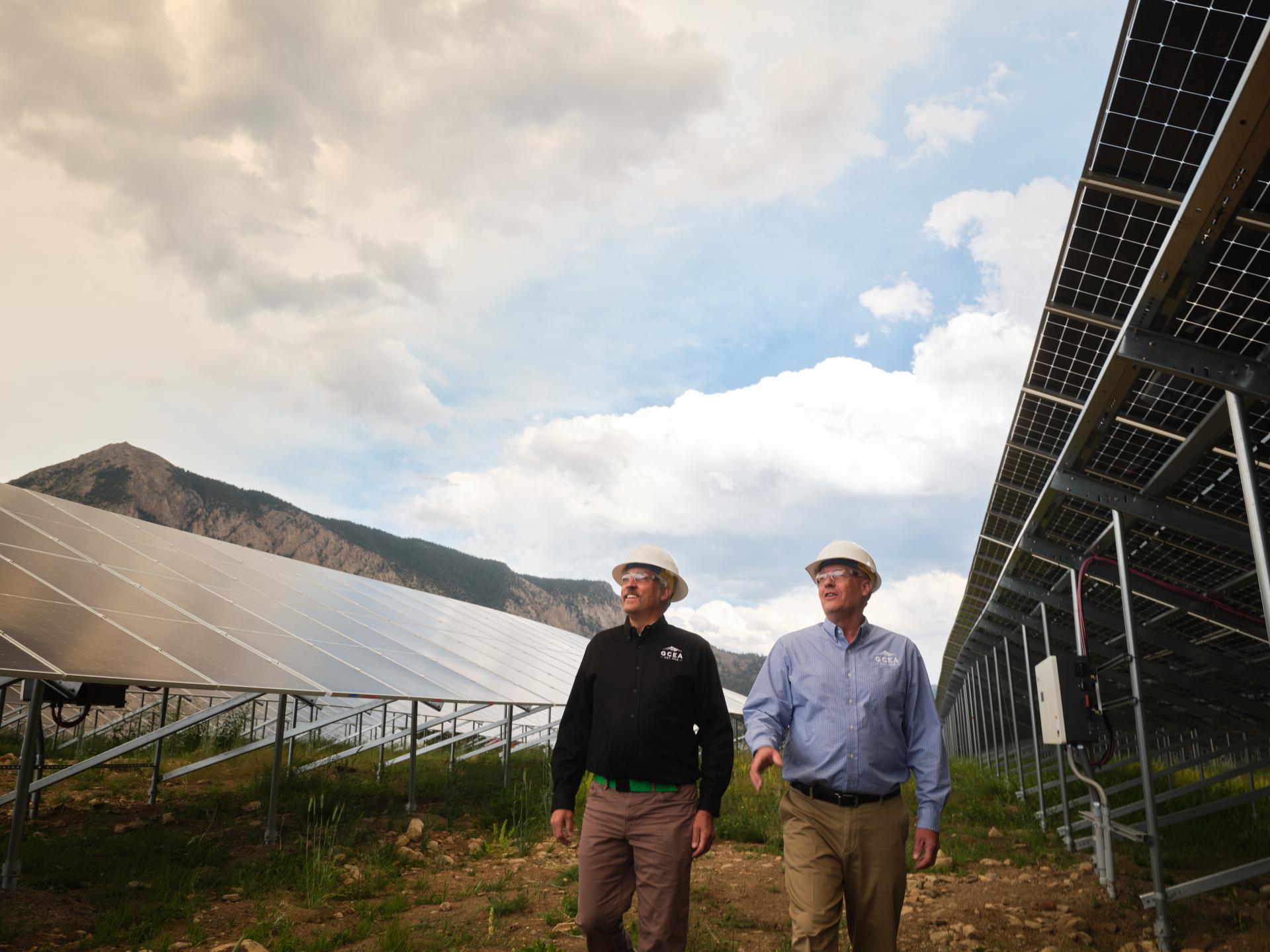 Matt Feier and Mike McBride walking through the Oh Be Joyful solar panels