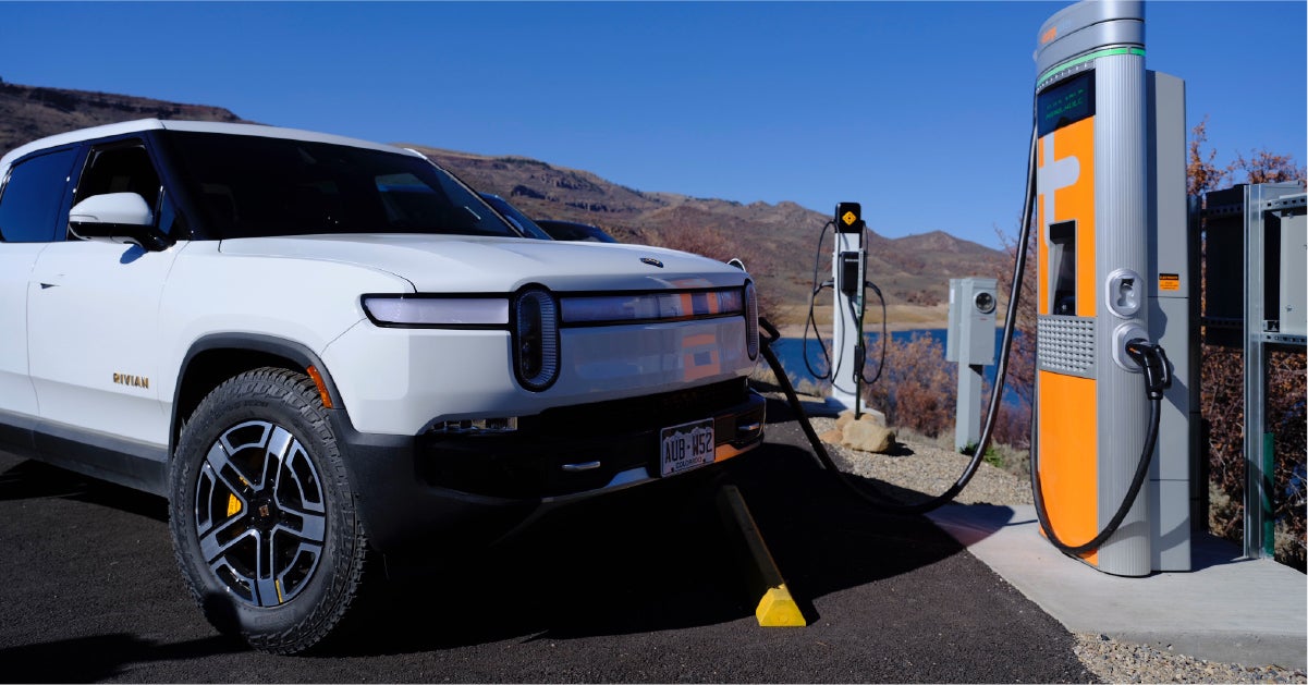 Rivian EV at charger by lake