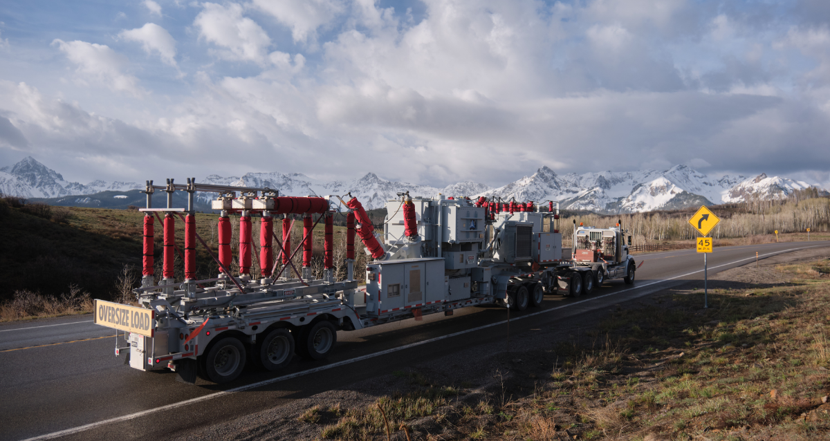 Mobile substation on road with snowy mountains in the back