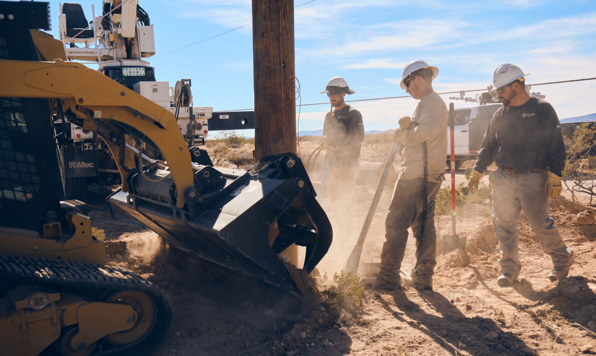 Three team members putting pole in