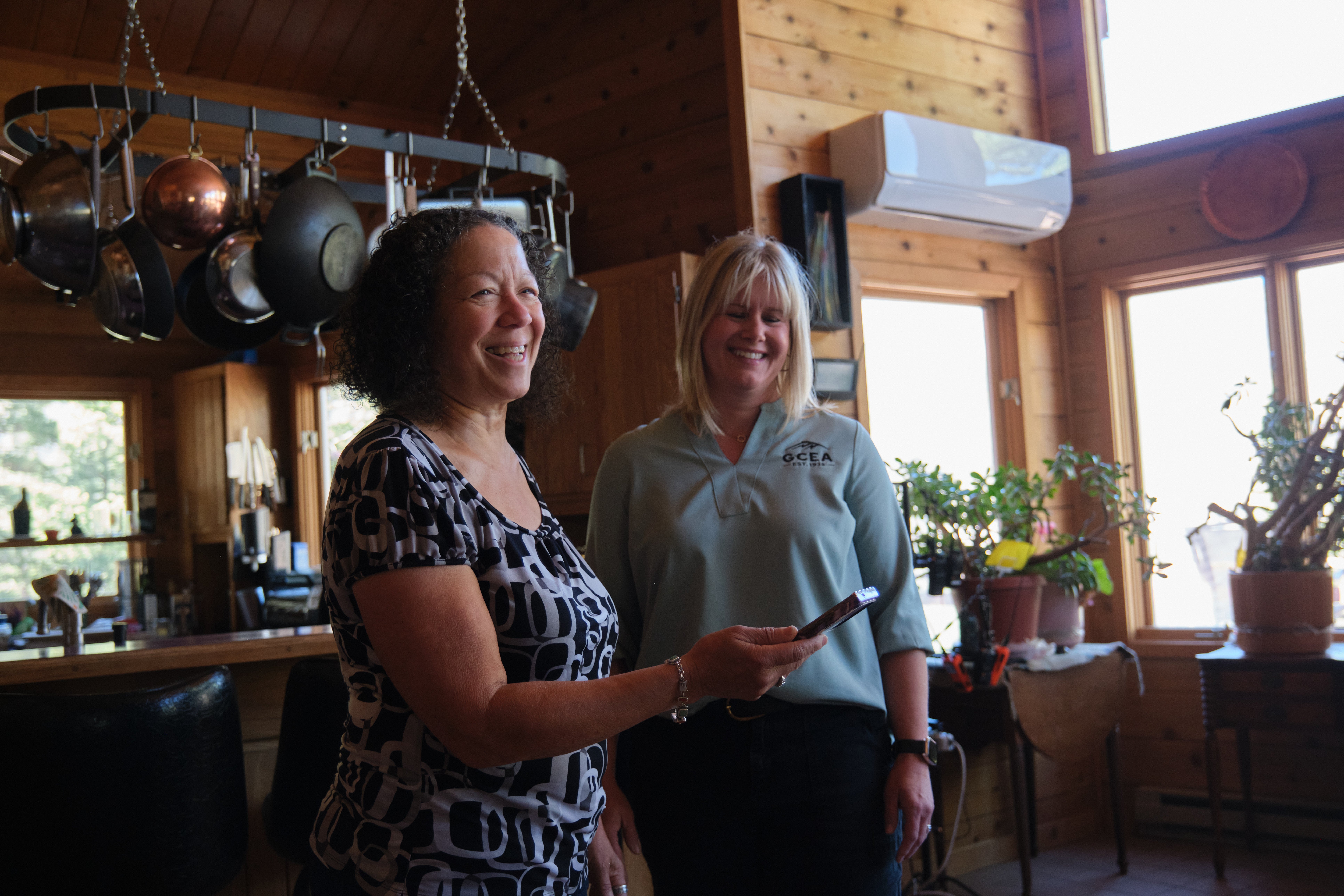 Carol Robinson and Alliy Sahagun in the home in front of Carol's mini-split