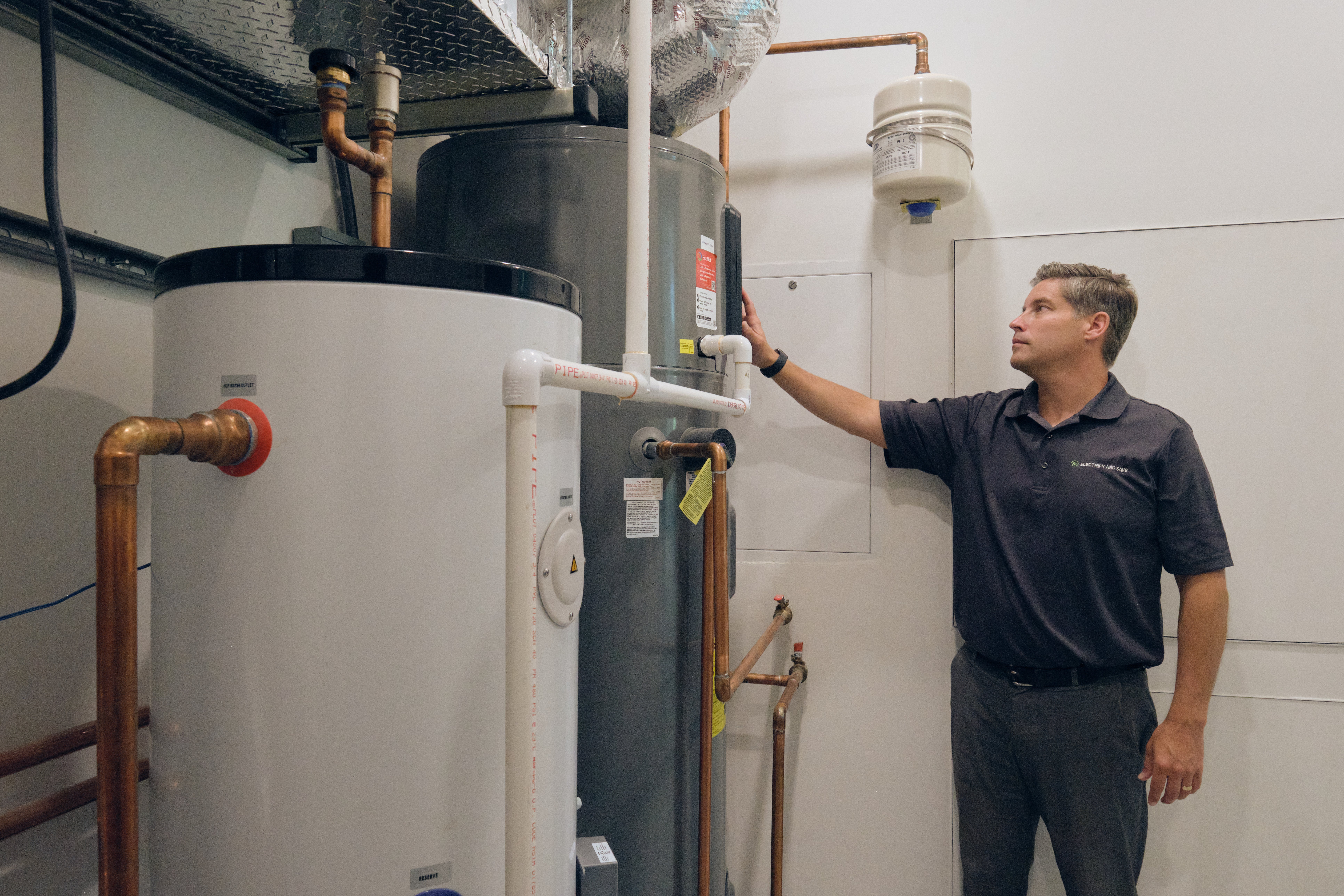 Pete Rusin standing inside the home's electrical room