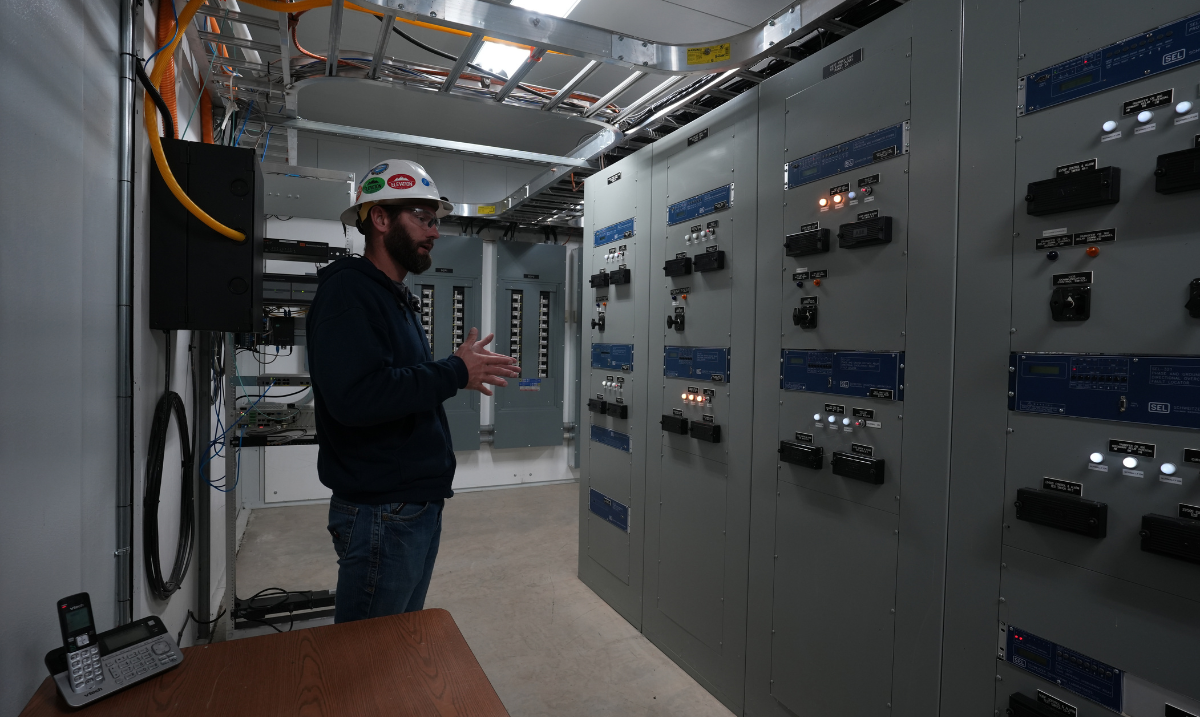 Jason Mckibben standing in front of equipment in station