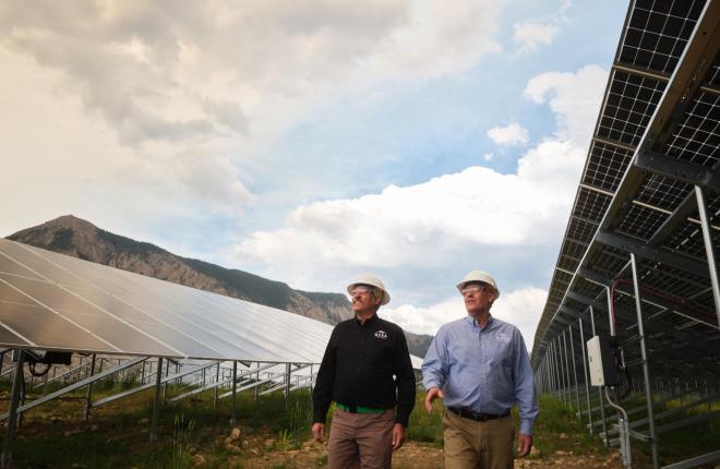Matt Feier and Mike McBride walking through the Oh Be Joyful solar panels