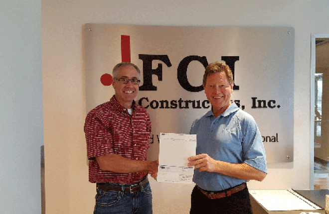 United Power co-op giving energy rebate check to FCI Constructors, Inc.