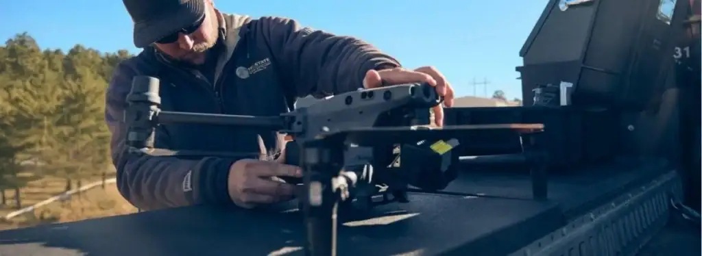 Drone pilot preparing a drone on a truck bed