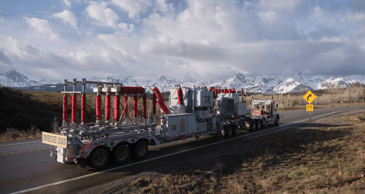 Mobile substation on road with snowy mountains in the back
