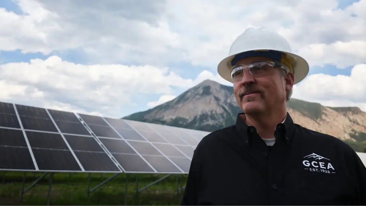 Matt Feier in front of solar panels