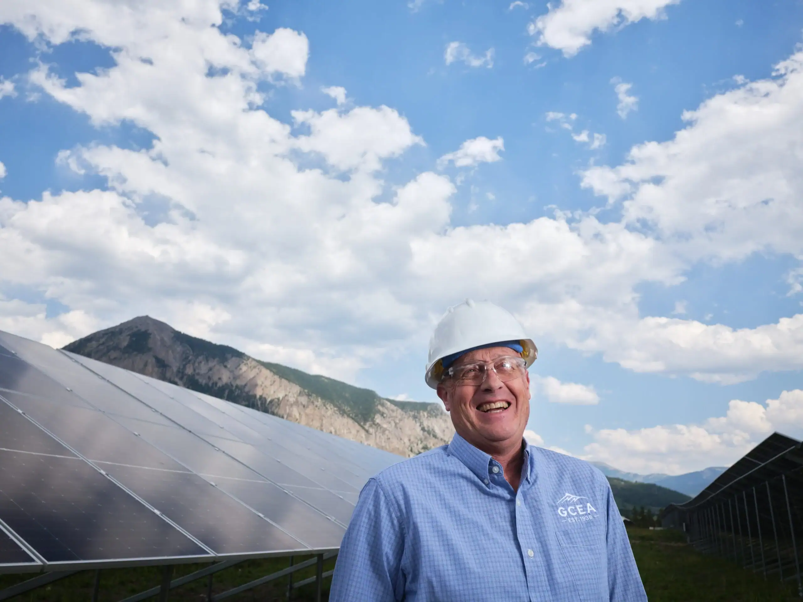 Mike McBride in front of solar panels